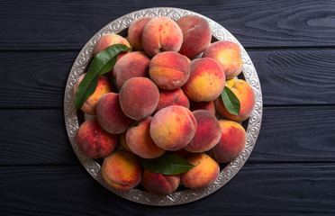 Fototapeta na wymiar Ripe peaches fruit on rustic background