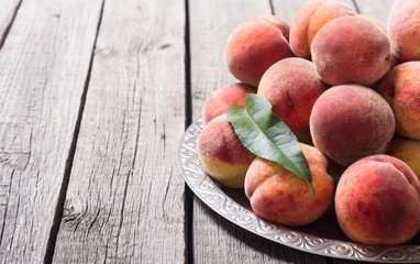 Fototapeta na wymiar Ripe peaches fruit on rustic background