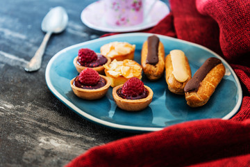 Mixed dessert Raspberry tartlet, Eclair Puffs, almond lemon