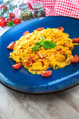 Seafood ​​tagliatelle cream sauce and vegetables