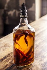 Pepper Oil on a table desk, ligth behind it