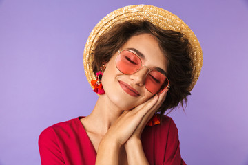 Pleased Pretty brunette woman in dress, straw hat and sunglasses