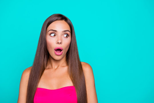 Portrait of young straight-haired sweet brunette girl wearing pink top, showing facial wow expression. Copy space. Isolated over bright vivid turquoise background