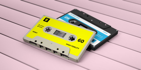 Retro audio cassette tapes with blue label isolated on pink wooden background. 3d illustration