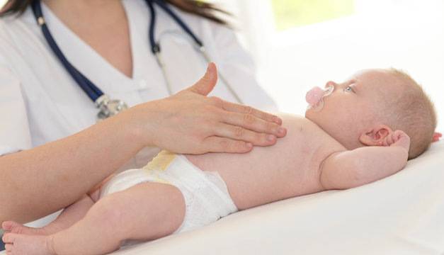 Pediatrician examining baby