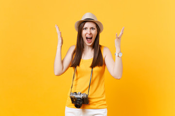 Shocked tourist woman in summer casual clothes, hat with retro vintage photo camera isolated on...