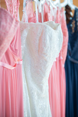 Wedding Dress and pink bridesmaids dresses Hanging