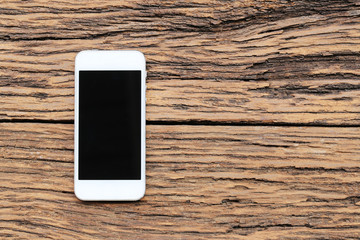 Empty Smartphone on brown wooden floor and have copy space.