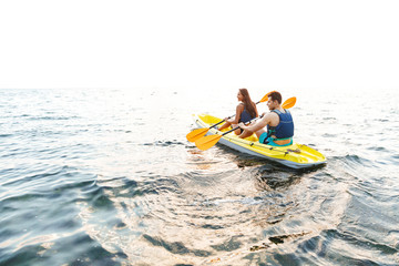 Fototapeta na wymiar Attractive young couple kayaking on lake