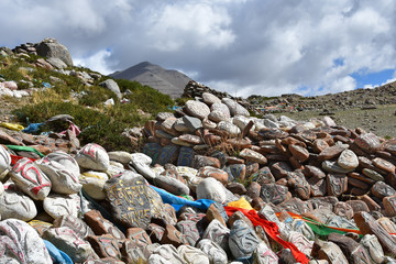 Tibet. Buddhist prayer stones with mantras and ritual drawings on the trail from the town of Dorchen around mount Kailash