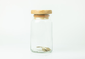 less money in a jar on white background