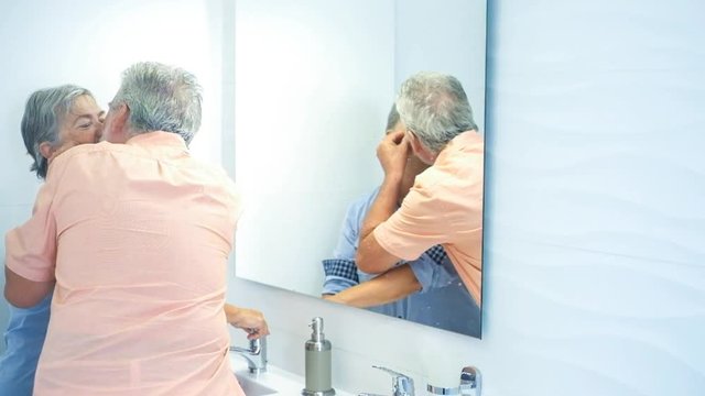 Couple Of Adult Caucasian Man And Woman At Home Playing Together In The Bathroom While Getting Ready And Prepare To Start The New Day. Everyday Forever Family Concept. Morning At Home