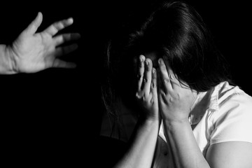 Aggression in the family, man beating up his wife. Domestic violence concept.