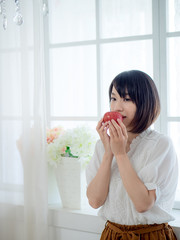 Woman having breakfast on window