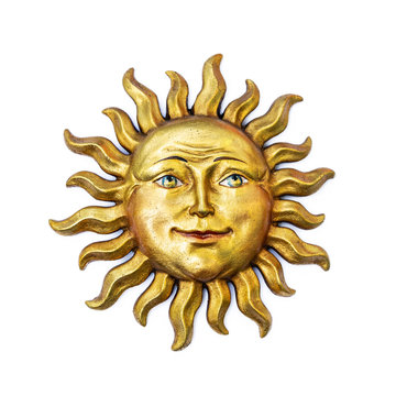 Golden sun face symbol with sunrays isolated on white. Wooden decor ornament symbol painted on gold paint. Summer weather and heat sign