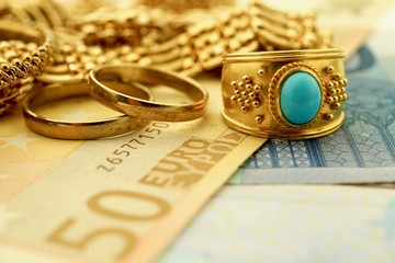 Vintage gold jewelry and euro notes