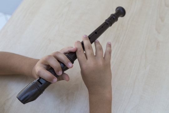 child playing flute in a music school for education concept.