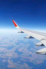 Wing aircraft flying above the ground at an altitude of 10,000 meters