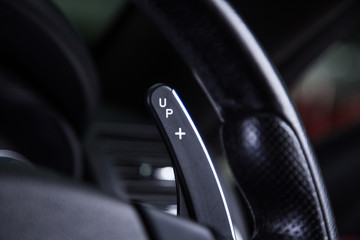 Obraz na płótnie Canvas Gear paddle shift detail on black steering wheel