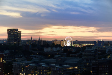 Dancing towers and Ferris Wheel of Hamburg's Dom at sunset