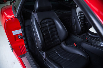 Detail of black leather sports car seat