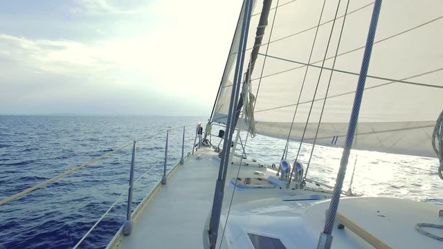 Sailing yacht off shore with beautiful sunset. 4k Video.