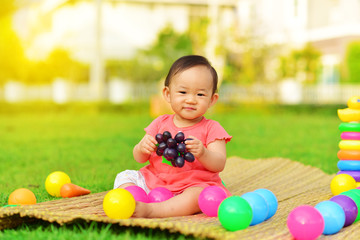 Fototapeta na wymiar Cute Asian baby playing with toys in playground 