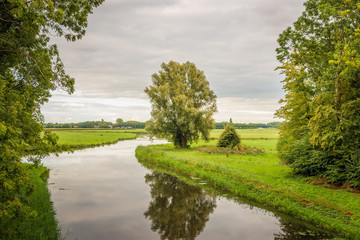 Fototapeta na wymiar Meandering stream in a Dutch landscape