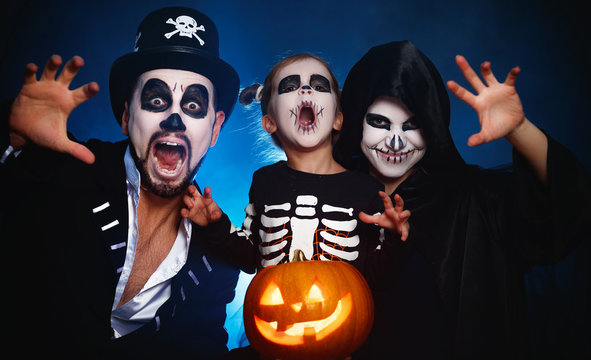 happy family mother father and child  in costumes and makeup on  Halloween.