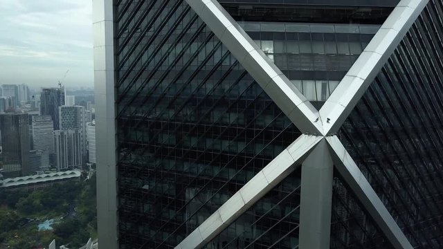 Aerial close central Ilham Baru Tower steel skyscraper black glass. Unique eastern style capital Kuala Lumpur Malaysia. Drone flight in downtown business district. Cinematic epic 4k footage.
