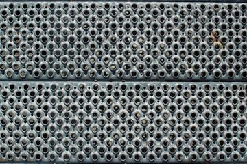 Perforated metal steps closeup as industrial background