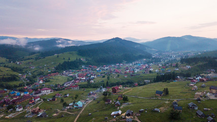 Fototapeta na wymiar Village in the mountains from a bird's eye view during sunset