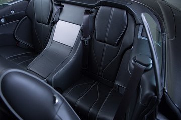 Black leather passenger seat of convertible sports car