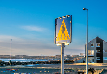 Pedestrian crossing sign in small road