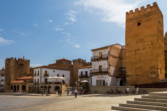 Plaza Mayor of Caceres in a beautiful and sunny day. Monumental walled square full of ancient buildings. Center of life and commerce of the city.