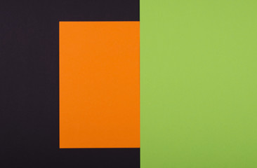 Handcraft paper background with orange, green, black paper. Place for your text. Unfocused view