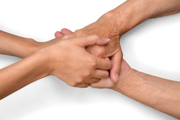 Fototapeta premium Young Woman's Hands Touching and Holding an Old Woman's Hands