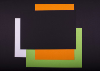 Handcraft holiday background from white, green, orange, black paper for Halloween design. Place for your text.