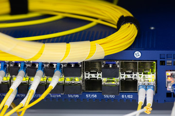 Close up fiber optic in server room , network cables installed in the rack Abstract image for use...