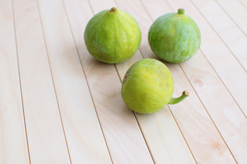 Fresh green figs Isolated Wooden background Copy space Autumn Fall Local market concept