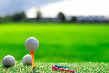 Golf ball on tee on golf course.