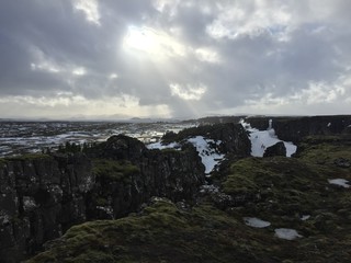 Sunlight breaking through icelandic rocky landscape, clouds, hiking, nature, outdoors