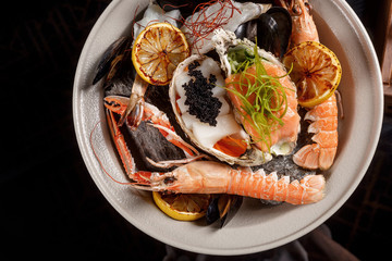 Seafood on hot stones with fish broth with lemongrass, kafir lime and orange.
