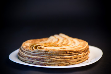 boiled sweet pumpkin porridge with raisins and nuts in a glass bowl