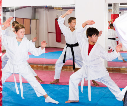 Kids in kimonos practicing effective karate techniques