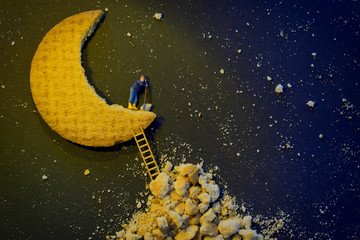 Miniature worker repairing the half moon