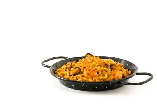 Traditional Spanish fideua. Noodle paella isolated on white background. Copyspace