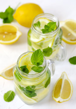 Mason jar glass of lemonade with mint on white background