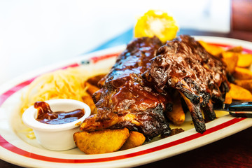 Grilled steak - Grilled meat ribs on the plate with hot sauce