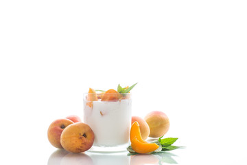 homemade yogurt with ripe apricots on a white